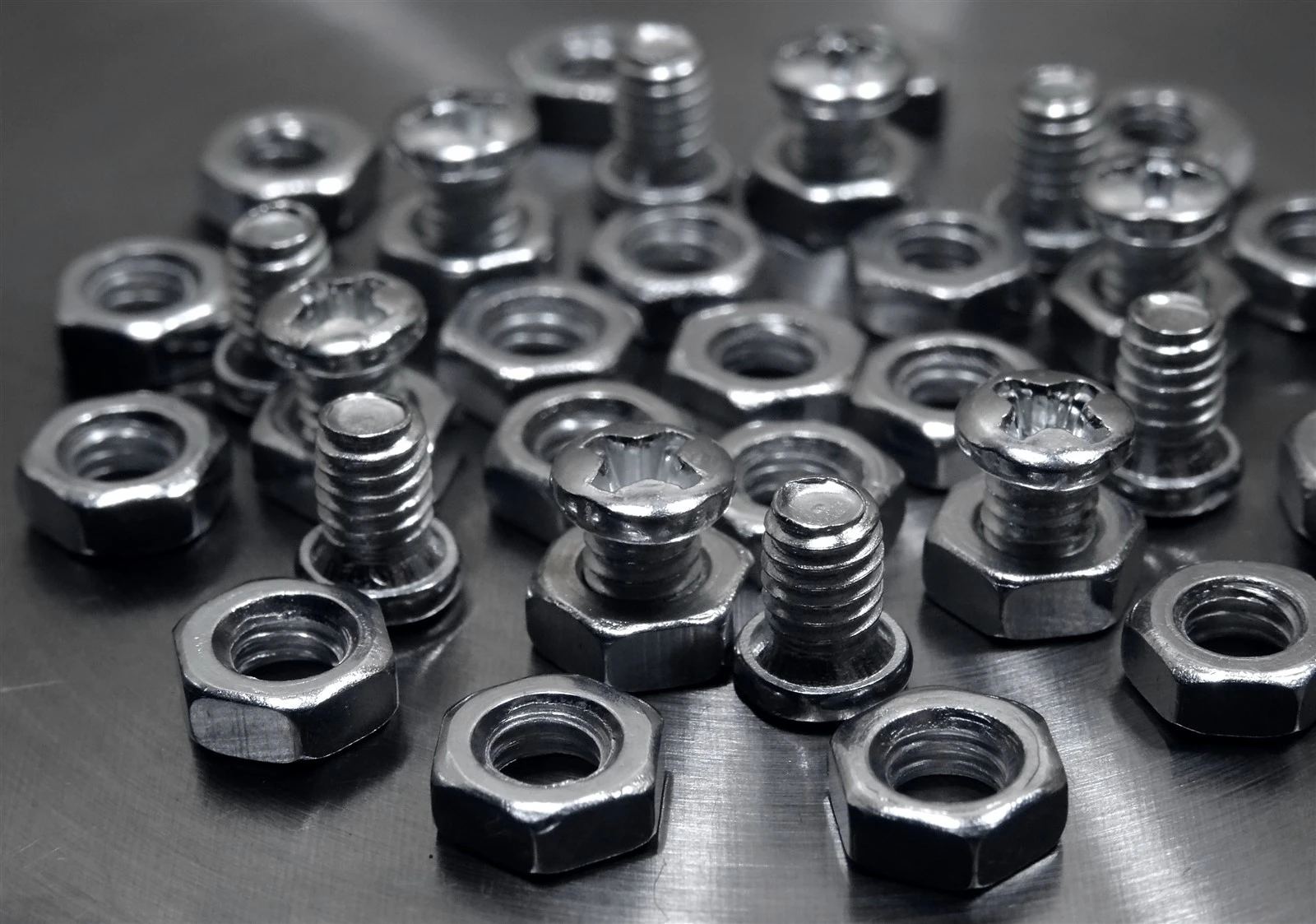 screw-bolts-hex-nuts-polished-metallic-surface
